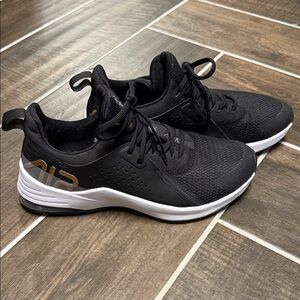 Nike Black Athletic Sneakers with White Sole and Gold Accent